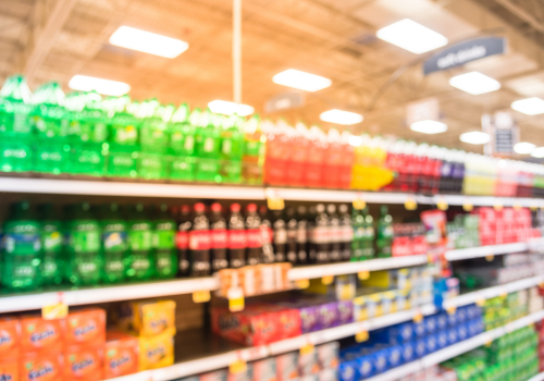 A blurred image of soft drinks in a supermarket 